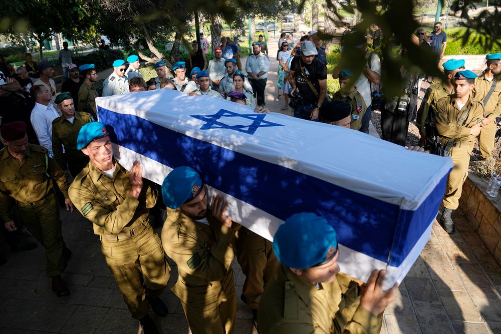 Israeli soldiers carry the flag-covered coffin of Staff Sgt. Maksym Molchanov during his funeral in Kiryat Shaul military cemetery in Tel Aviv, Israel.